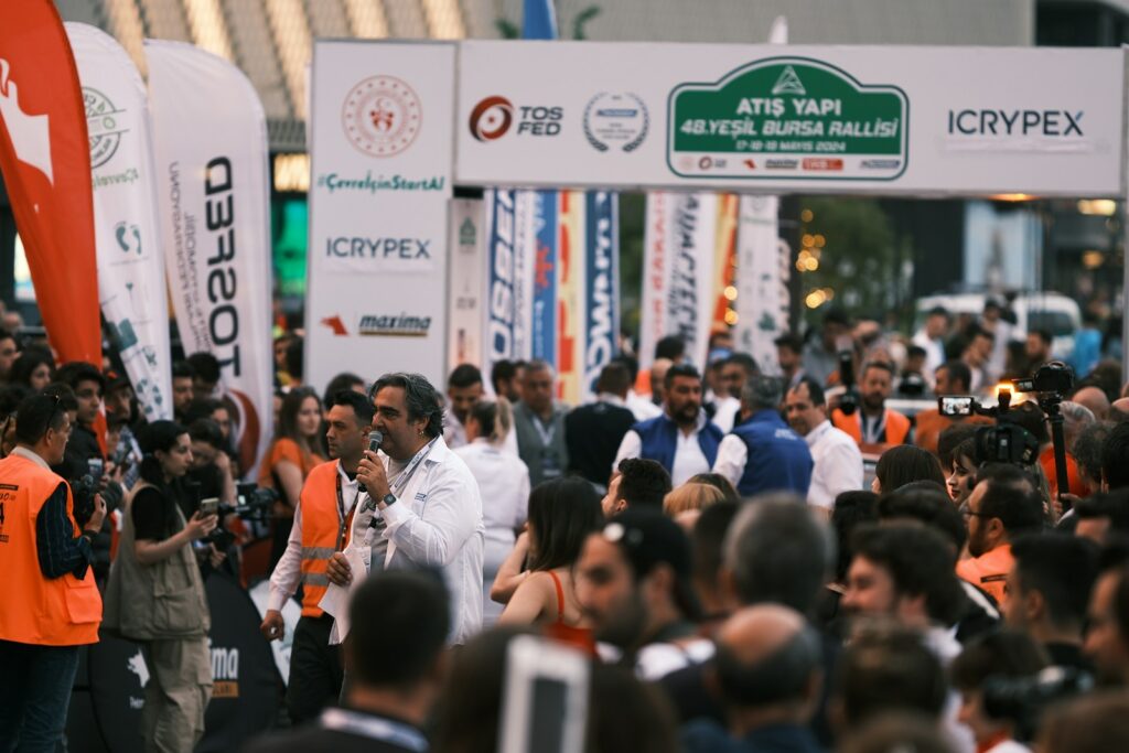 a crowd of people standing around each other